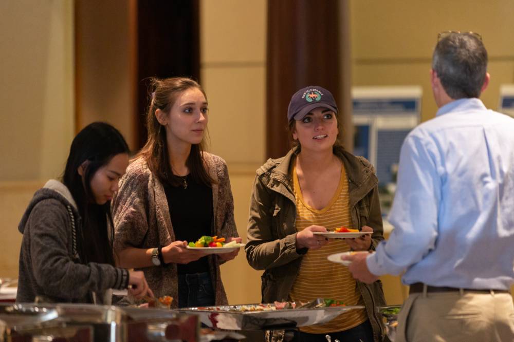 People connect over a bite to eat before the Arnold C. Ott lecture, Oct 4